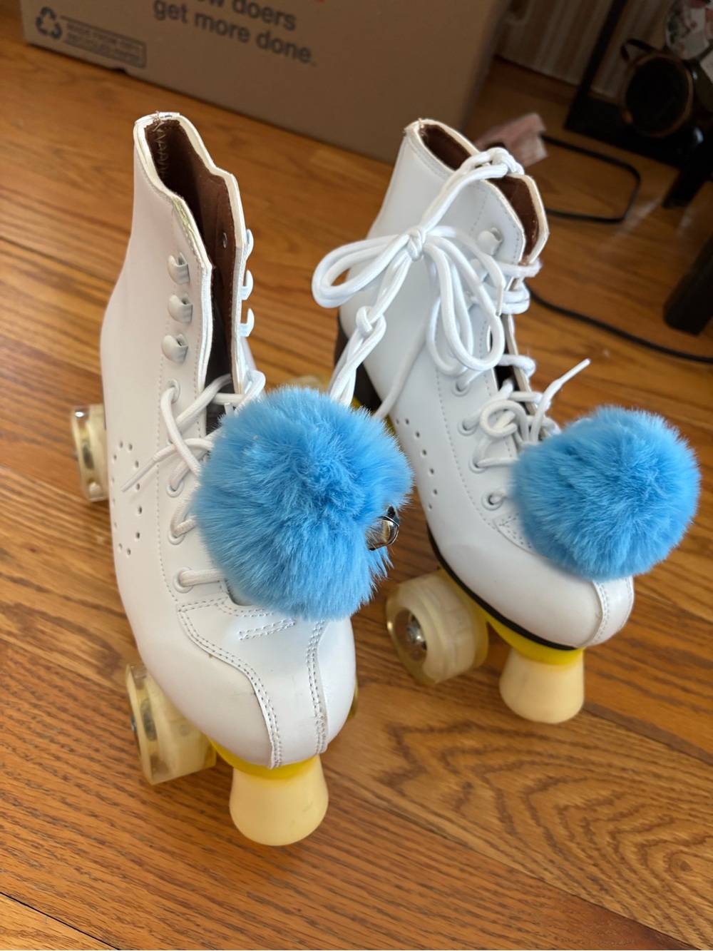White Leather Quad Roller Skates with Blue Pom Pom Charms